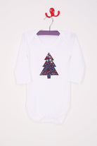 A white bodysuit babygrow with a Liberty Adelajda's Wish print Christmas tree sewn on the front.