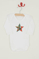 A white bodysuit babygrow with a Liberty My Little Star print festive star sewn on the front.