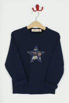 A navy long sleeve christmas t-shirt with a festive star on the front made from Liberty Christmas print on the front.