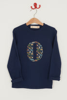 A personalised cotton navy long sleeve tee with an initial on the front made from Quey Zoo  animal Liberty print fabric.