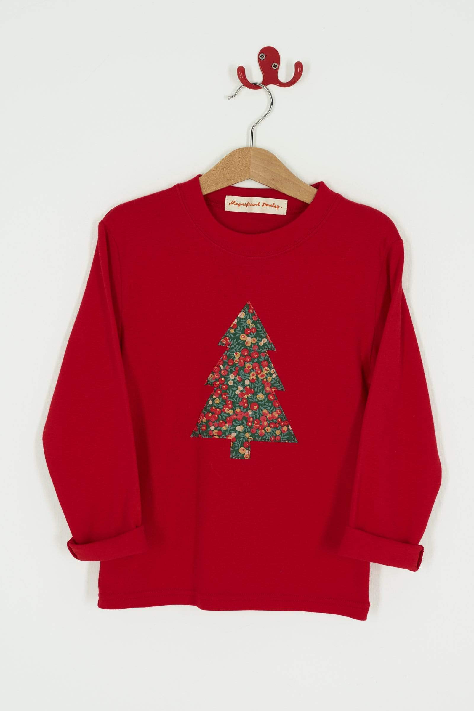 A festive red t-shirt with a Christmas tree on the front made from Liberty Glitter Wiltshire berry fabric.