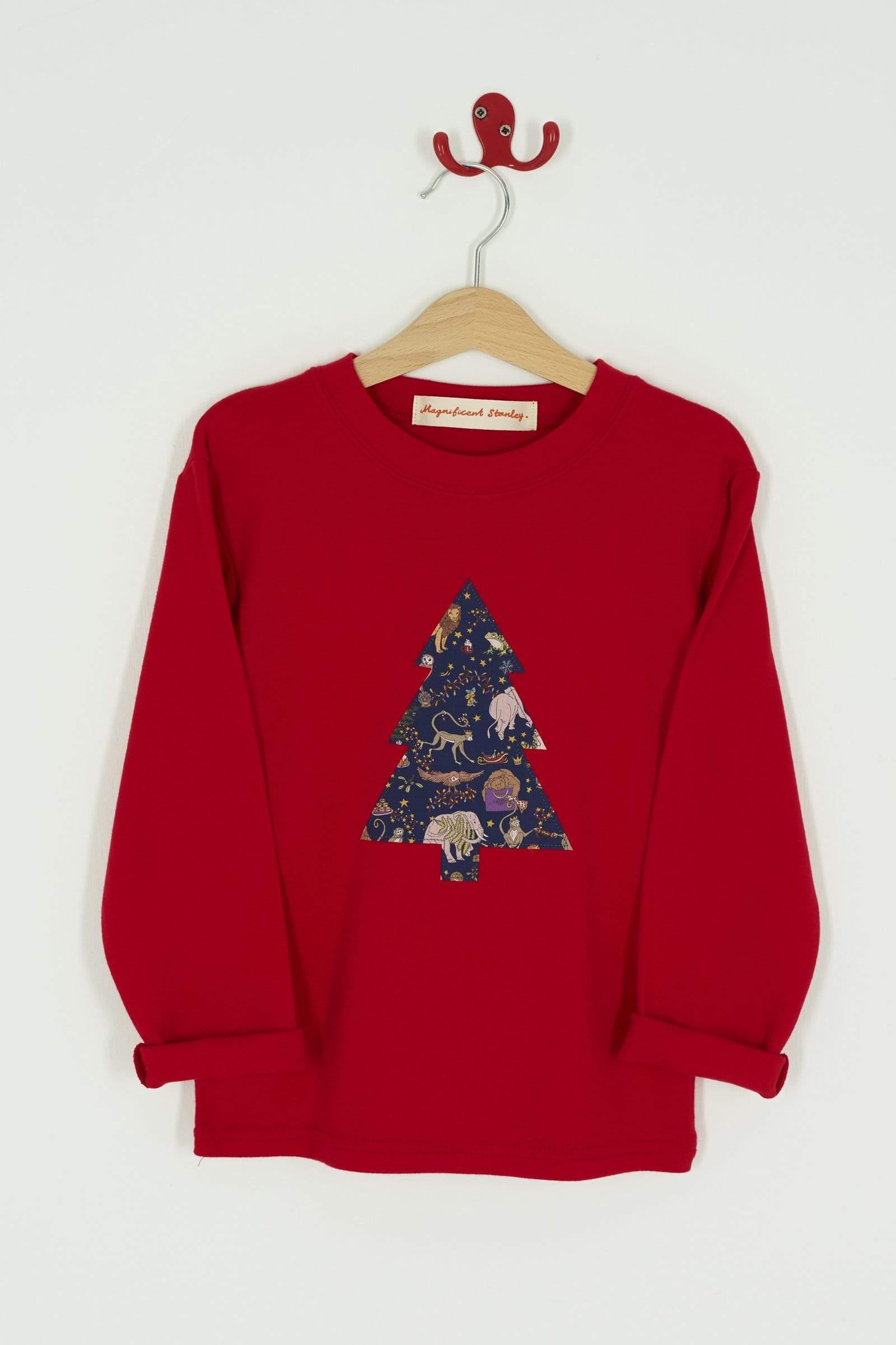 A festive red t-shirt with a christmas tree on the front made from Liberty Christmas fabric.